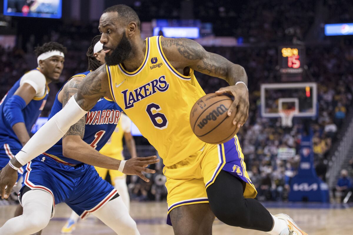 The Lakers' LeBron James drives against Golden State's Damion Lee on Feb. 12, 2022.