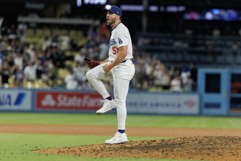 LOS ANGELS, CA - AUGUST 21, 2024: Los Angeles Dodgers pitcher Alex Vesia (51) reacts after striking out Seattle Mariners outfielder Randy Arozarena (56) to end the game and give the Dodgers the 8-4 win at Dodgers Stadium on August 21, 2024 in Los Angeles, California. (Gina Ferazzi / Los Angeles Times)