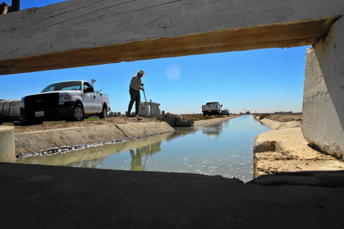 Al Necochea, a zanjero with the Imperial Irrigation District, checks water flow into a farm in the Imperial Valley in 2011.