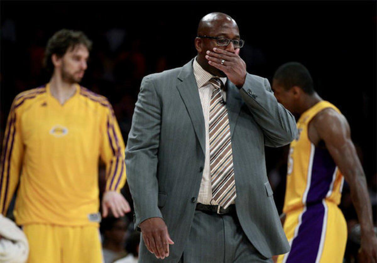 Mike Brown wipes his face as the Lakers fall to 0-3, after a loss to the Clippers.