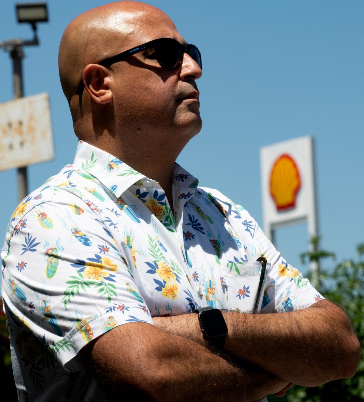 Bahu stands across the street from a Shell station where he alleges corruption preserved an "illegal monopoly interest."