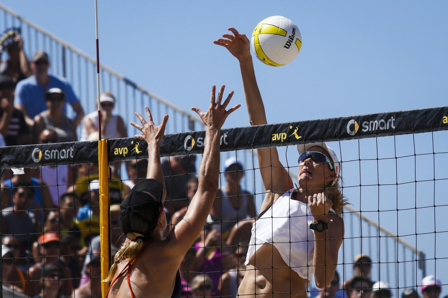 Kerri Walsh Jennings hits the ball against Heather Hughes during the Women's AVP Pro Beach Volleyball Championship final on Sunday in Huntington Beach.