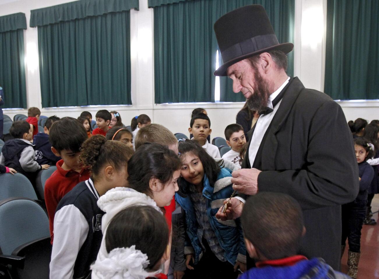 Second graders mingle with actor J.P. Wammack as Abraham Lincoln after he spoke at Marshall Elementary School in Glendale on Wednesday, Feb. 5, 2014. Wammack, as the 16th president, gave a 30 minute talk about the history of the president we all know as Honest Abe.