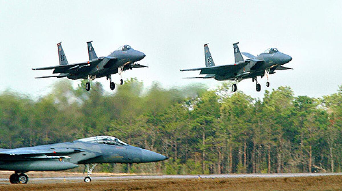 Two F-15 Eagle fighter jets prepare to land in Florida as another waits to take during a"surge" training exercise in this January 2006 photo. Two similar fighter jets from Eglin crashed into the Gulf of Mexico during a training mission, fatally wounding one of the pilots.
