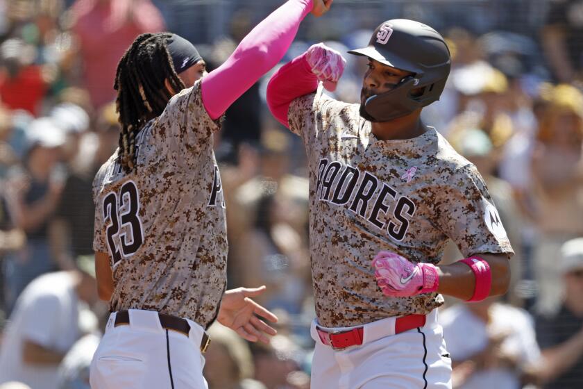 San Diego CA - May 12: San Diego Padres' Xander Bogaerts celebrates a solo home run with Fernando Tatis Jr., left, in the fifth inning against the Los Angeles Dodgers at Petco Park on Sunday, May 12, 2024 in San Diego, CA. (K.C. Alfred / The San Diego Union-Tribune)