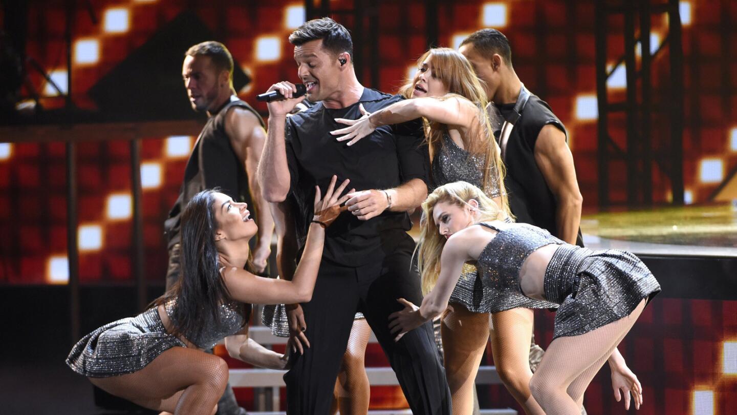 Ricky Martin surrounded by his backup dancers.
