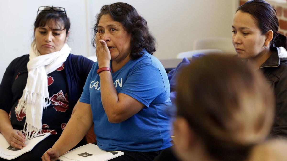Susana Zamorano, parent coordinator and organizer for the immigrants right organization Carecen, wipes away a tear during a workshop held by Victor Narro.