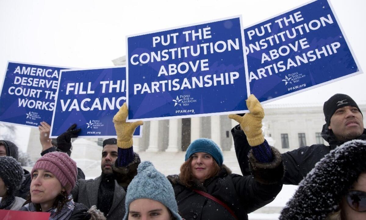 Demonstrators outside the Supreme Court on Monday call for the Senate to act on a nominee to succeed Justice Antonin Scalia.