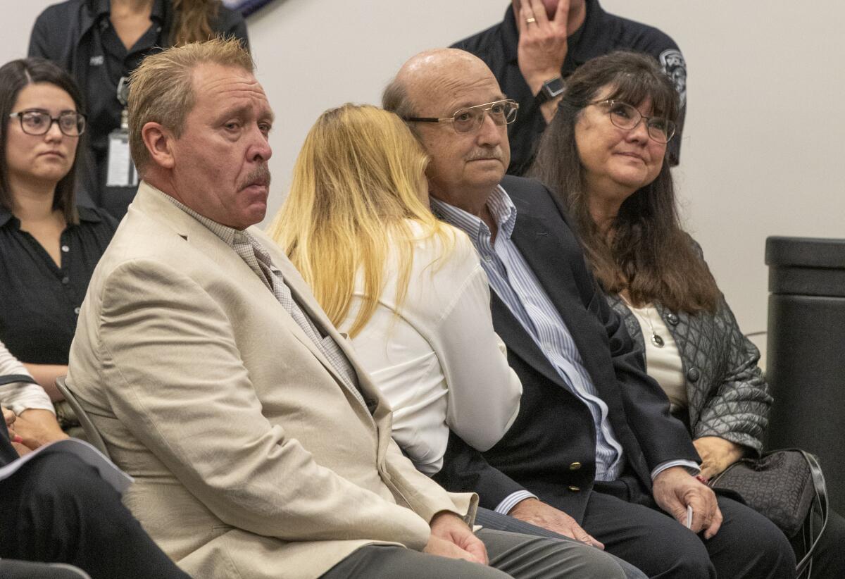 Tammy Hollis, center, hugs her brother, Randy Hollis, who are the sister and brother of kidnapping and murder victim Terri Lynn Hollis. Tammy Hollis's longtime boyfriend and Randy Hollis's wife sit on either side.