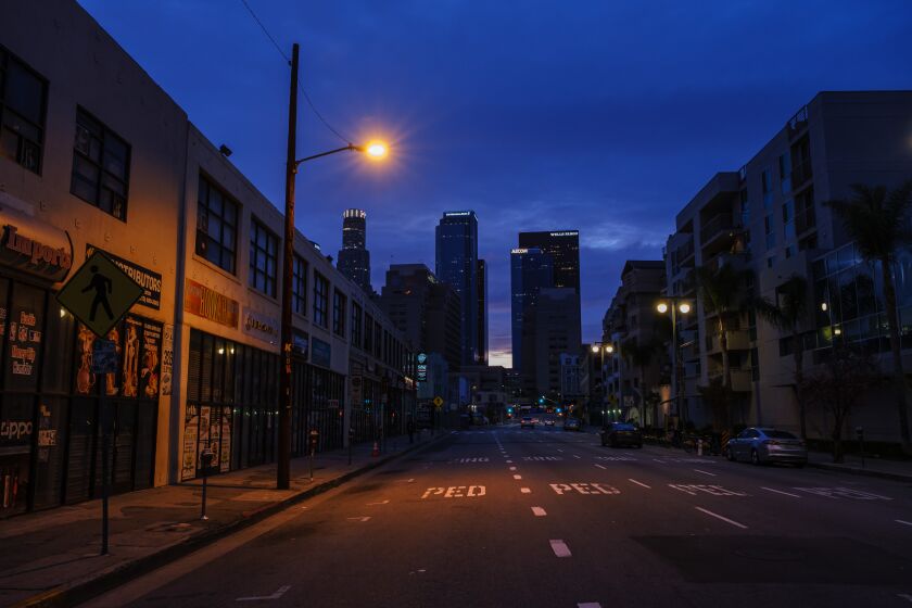 LOS ANGELES, CALIF. -- MONDAY, APRIL 6, 2020: Dusk settles as the Third street which is usually streaming with traffic, sits empty in downtown Los Angeles, Calif., on April 6, 2020. In California, there are more than 16,363 confirmed COVID-19 cases, according to a tally maintained by the Los Angeles Times. At least 387 have died. (Marcus Yam / Los Angeles Times)