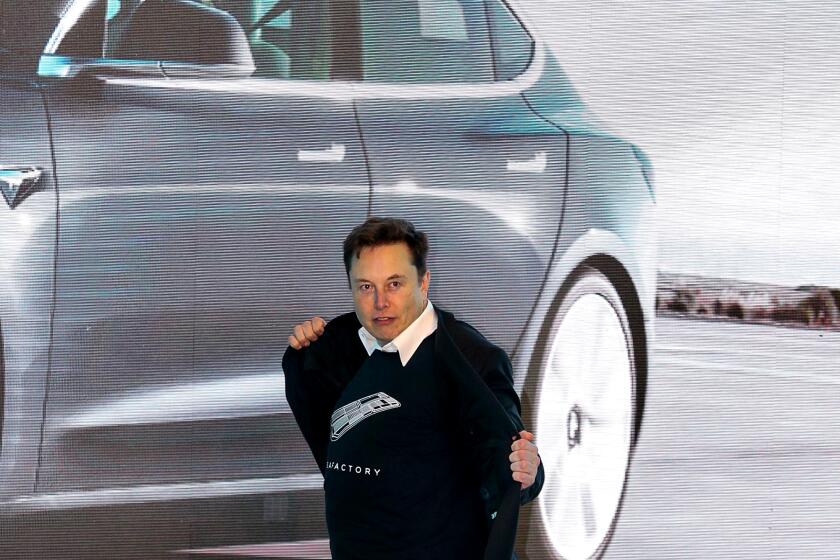 Tesla CEO Elon Musk dances during the Tesla China-made Model 3 Delivery Ceremony in Shanghai on January 7, 2020.