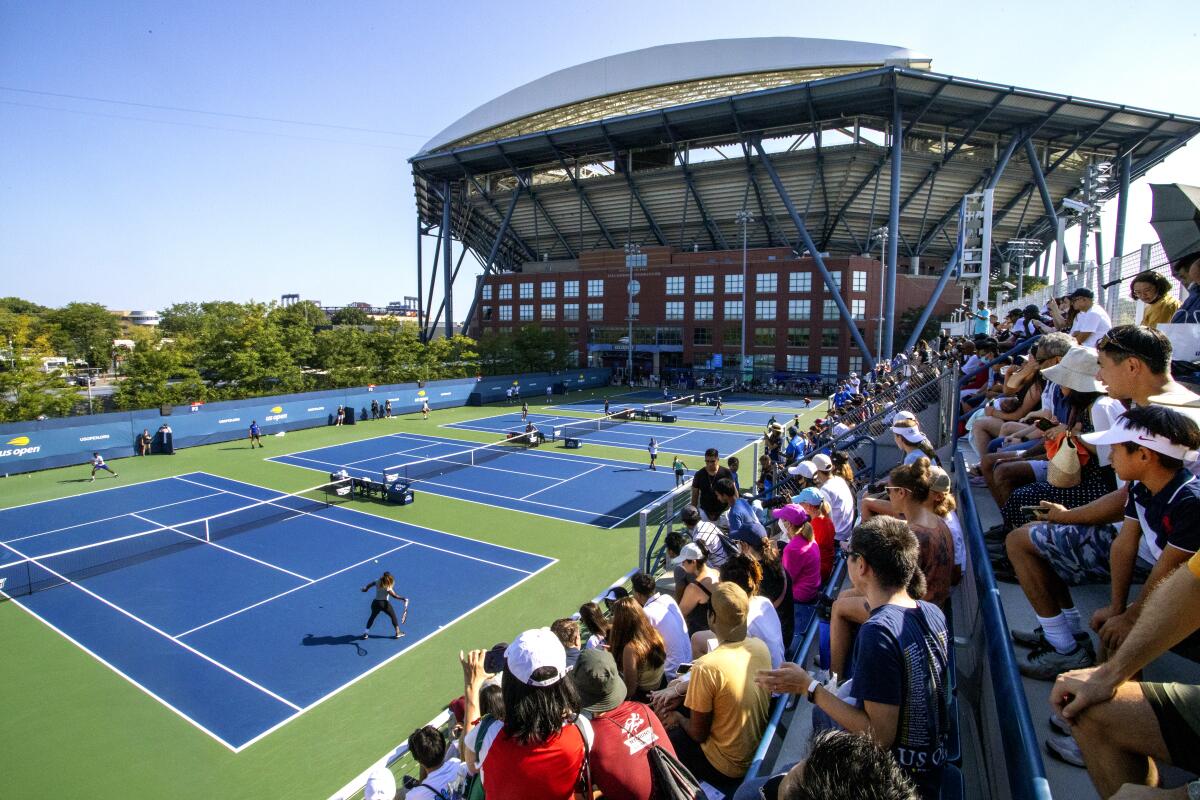 Spectators watch Serena Williams on the practice courts