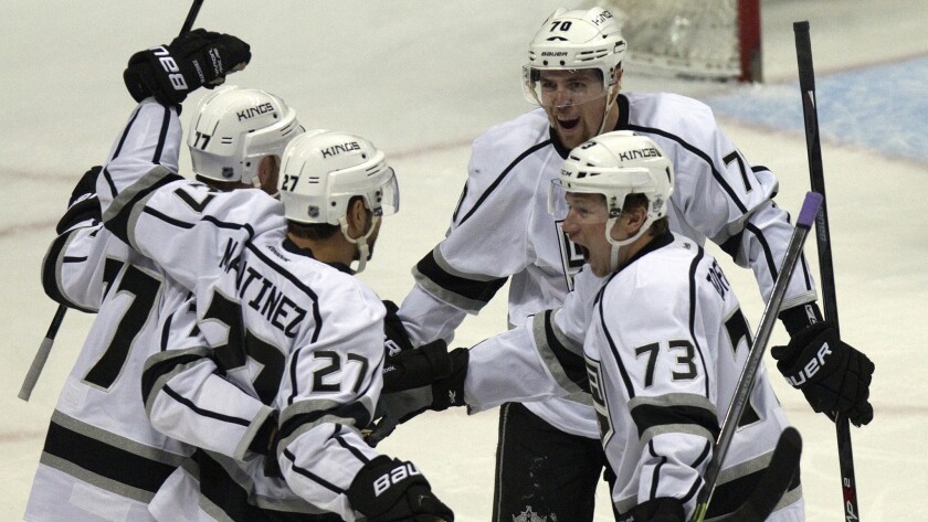 Kings defenseman Alec Martinez, second left, celebrates with teammates (from left to right) Jeff Carter, Tanner Pearson and Tyler Toffoli after scoring during the first period of the Kings' 3-1 win over the Ducks in Game 2 of the Western Conference semifinals at Honda Center on Monday.
