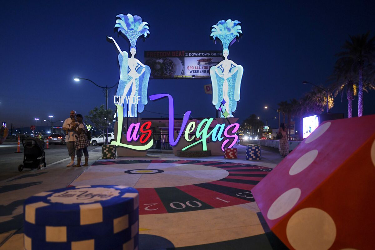 The Las Vegas gateway sign features showgirls and dice.