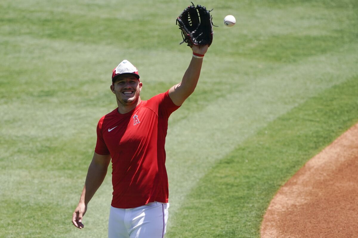 Angels center fielder Mike Trout catches a ball during practice at Angel Stadium on July 7.