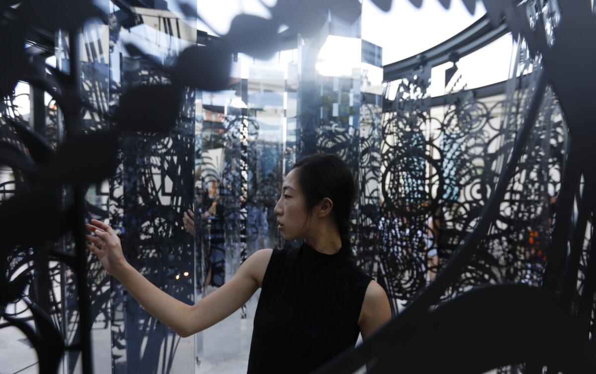 Haihua Chiang, 25, of Assembly Dance group moves around the Elizabeth Turk exhibition “Tipping Point."