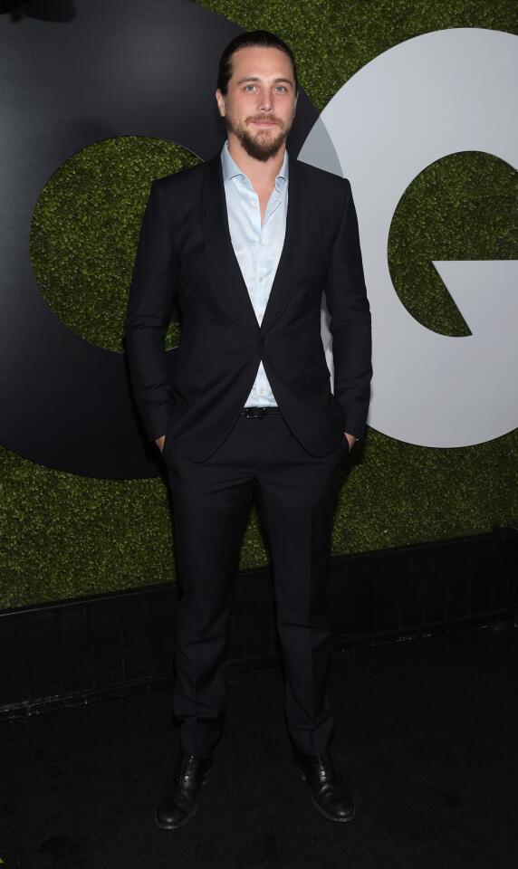 Actor Ben Robson pauses in front of the GQ logo.