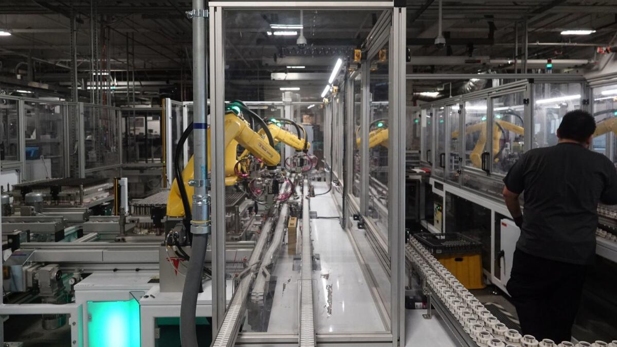 Robots at Tesla's Gigafactory in Reno, Nev., help assemble battery cells from Panasonic into battery packs for Tesla's Model 3 sedan and other products.