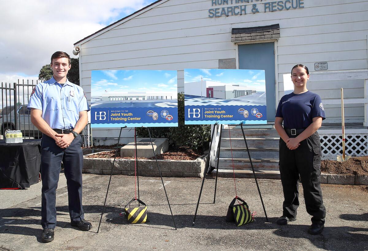 Fire explorer Ethan Atwood, left, and police explorer Lainie Shield, right, at Thursday's groundbreaking ceremony.