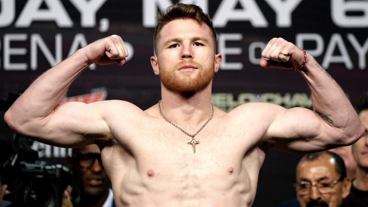 Canelo Alvarez flexes during his weigh-in on Friday at the MGM Grand in Las Vegas.