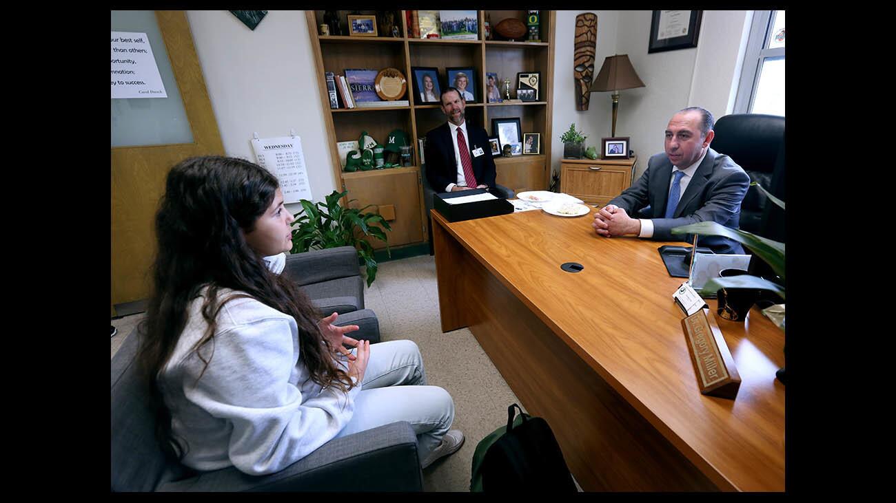 Principal for a day Leo Divinsky, right, speaks with ASB president and eighth grader Serineh Ter-Petrossyan, left, as real principal Dr. Gregory Miller looks on, at Muir Middle School in Burbank on Wednesday, Jan. 30, 2019. Divinsky is asset manager for Worthe Real Estate Group.