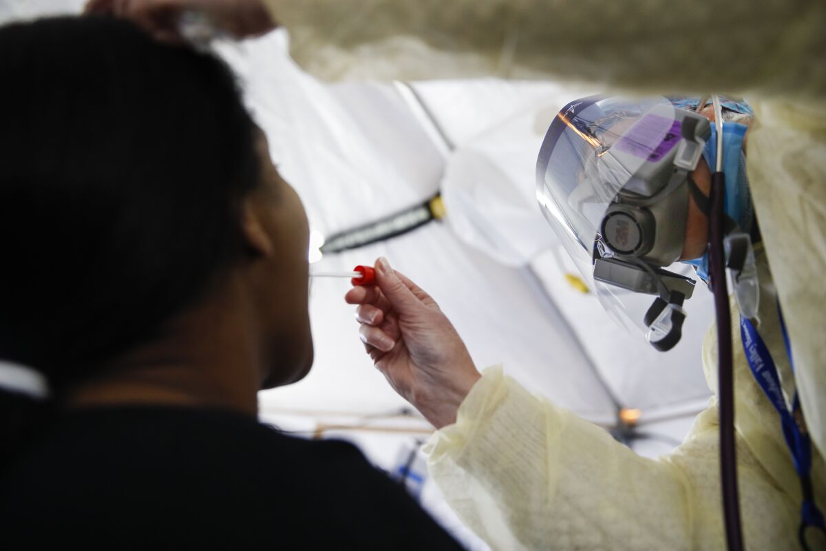 A test is performed on a patient in a COVID-19 triage tent at a Yonkers, N.Y., hospital.