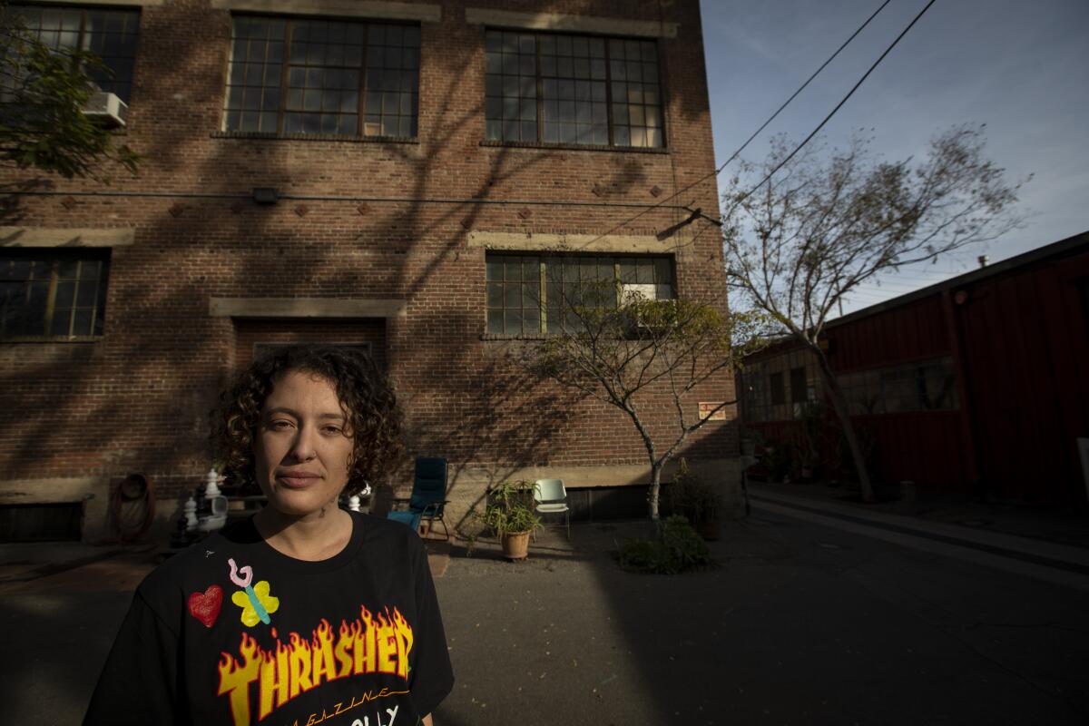 Santa Fe Art Colony resident Molly Conn, 25, outside the Los Angeles complex where many tenants have been hit with significant rent increases. 