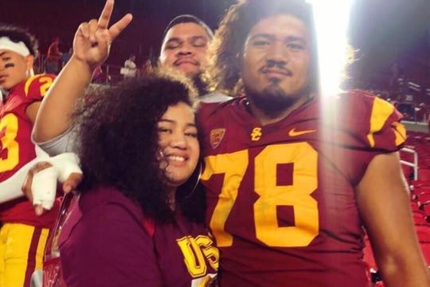 USC defenseman Jay Tufele with his sister Noreen after a football game.