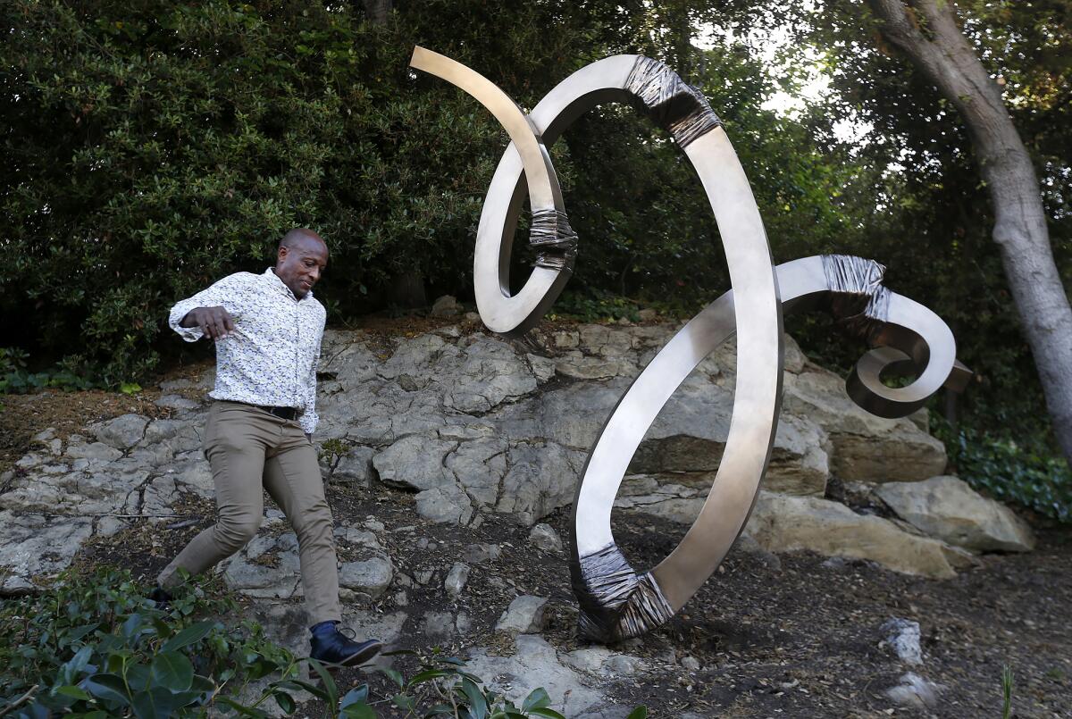 Laguna Beach artist Gerard Basil Stripling with "Emprise" Wednesday at the Festival of Arts grounds.