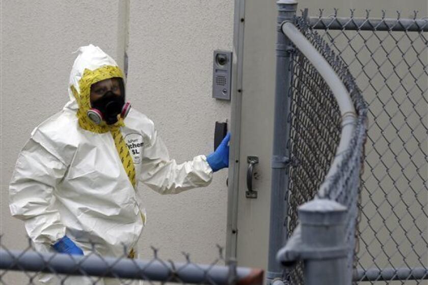 A firefighter in a protective suit walks into a government mail-screening facility in Hyattsville, Md.
