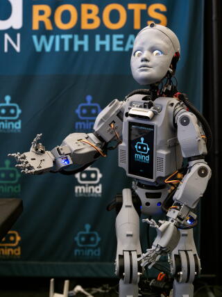 Codey, a proof-of-concept humanoid robot from Mind Children, stands in the exhibition hall.