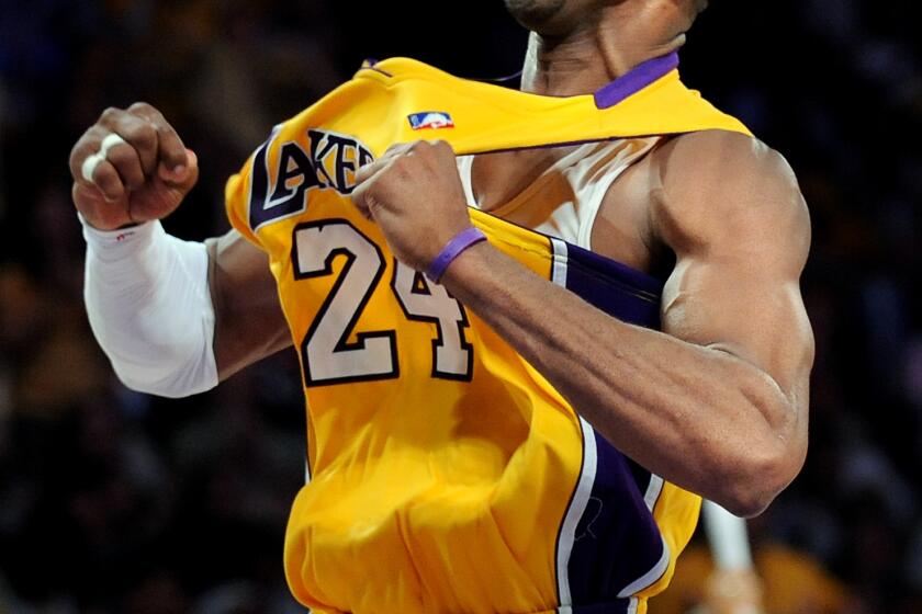 Lakers Kobe Bryant celebrates his three–pointer against the Nuggets