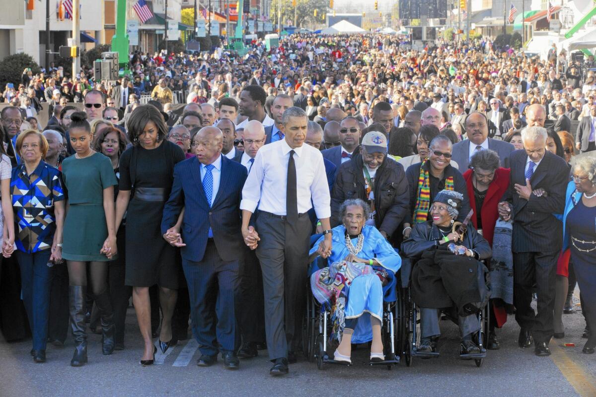 President Obama leads a march Saturday across the Edmund Pettus Bridge in Selma, Ala.