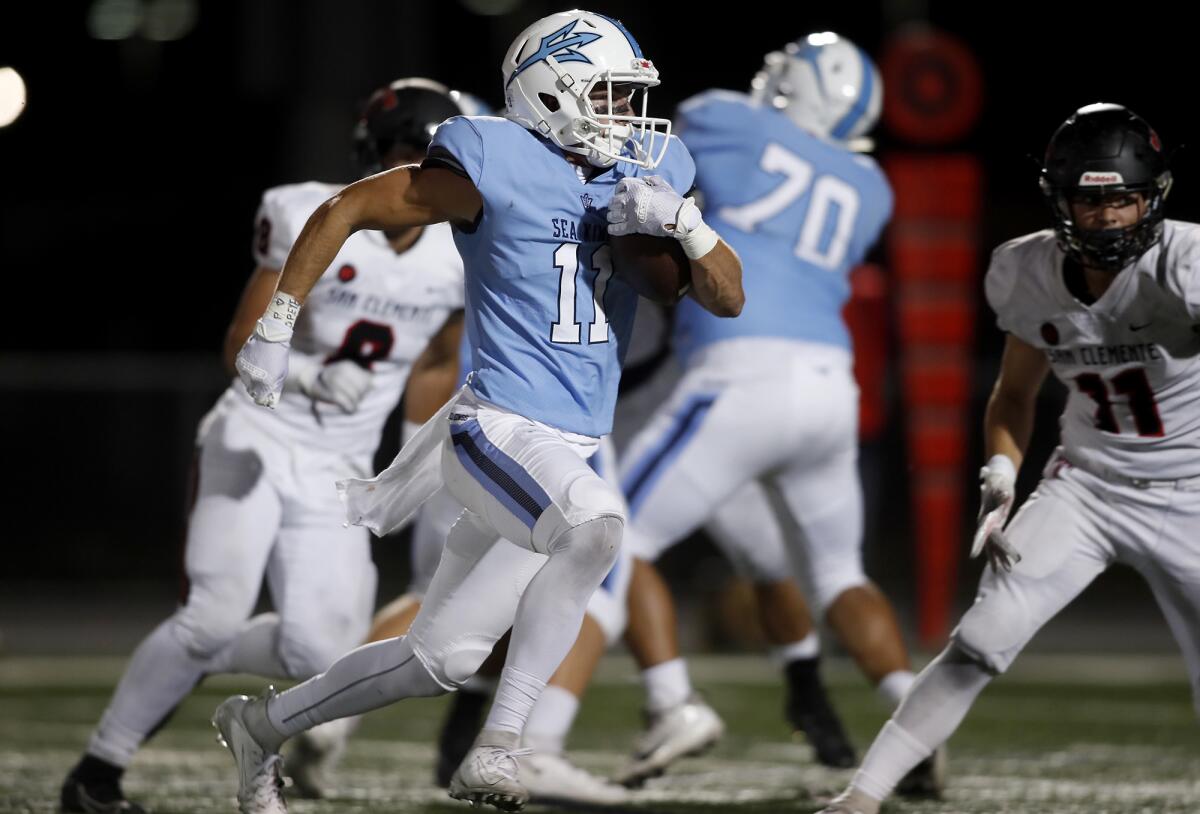 Corona del Mar's Bradley Schlom carries the ball against San Clemente in a nonleague game at Newport Harbor High on Sept. 26.