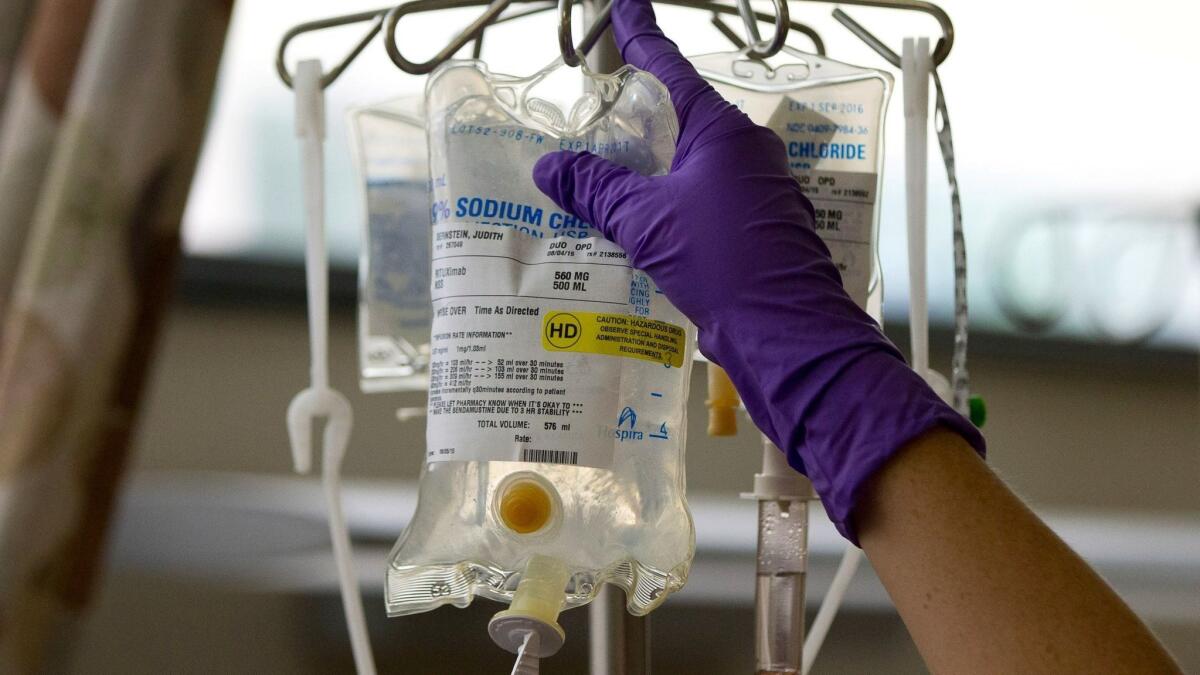 A nurse places a patient's chemotherapy medication on an IV stand at a hospital in Philadelphia.