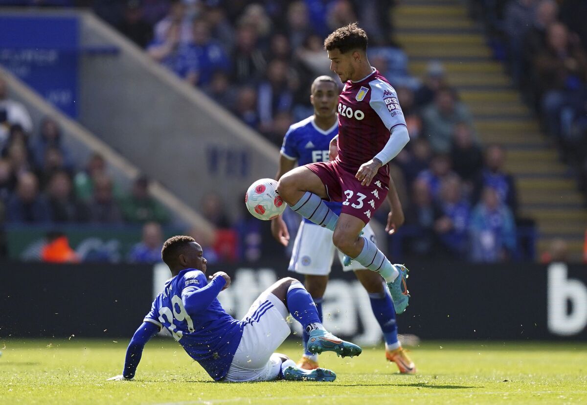 Leicester City's Patson Daka, left, tackles Aston Villa's Philippe Coutinho during the English Premier League soccer match between Leicester City and Aston Villa at the King Power Stadium, Leicester, England, Saturday April 23, 2022. (Mike Egerton/PA via AP)