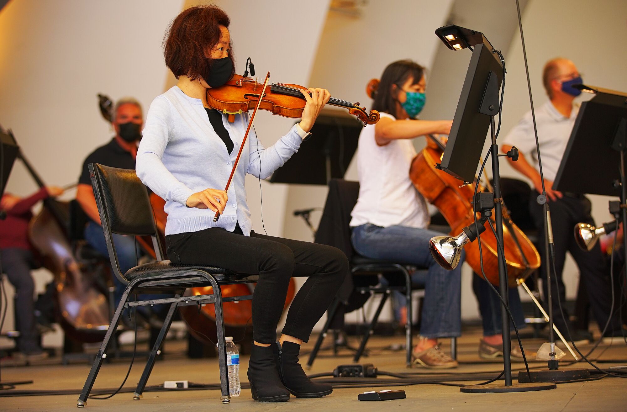 Musicians play stringed instruments at the L.A. Phil