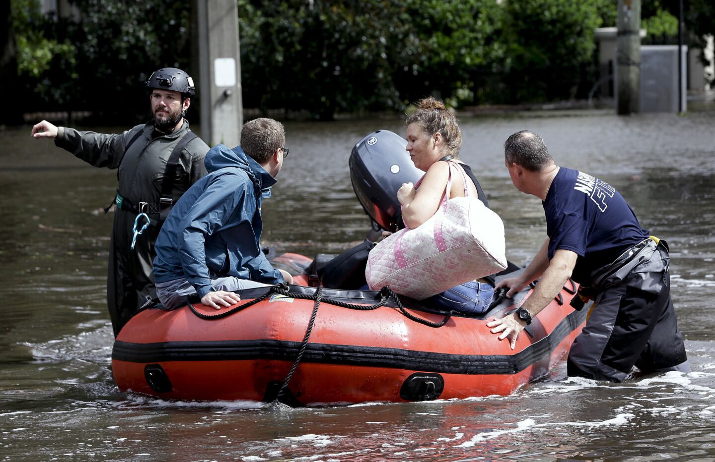 Rescue workers help a couple evacuate their flooded home in Jacksonville.