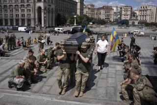 Ukrainian servicemen carry the coffin of British combat medic, volunteer, Peter Fouche, 49 who was killed on June 27 during his work in East Ukraine, at the funeral ceremony on the city's main square in Kyiv, Ukraine, Saturday, July 6, 2024. Peter was founder of a charity organization, which provides vehicles, drones and other needs to Ukrainian servicemen. (AP Photo/Alex Babenko)