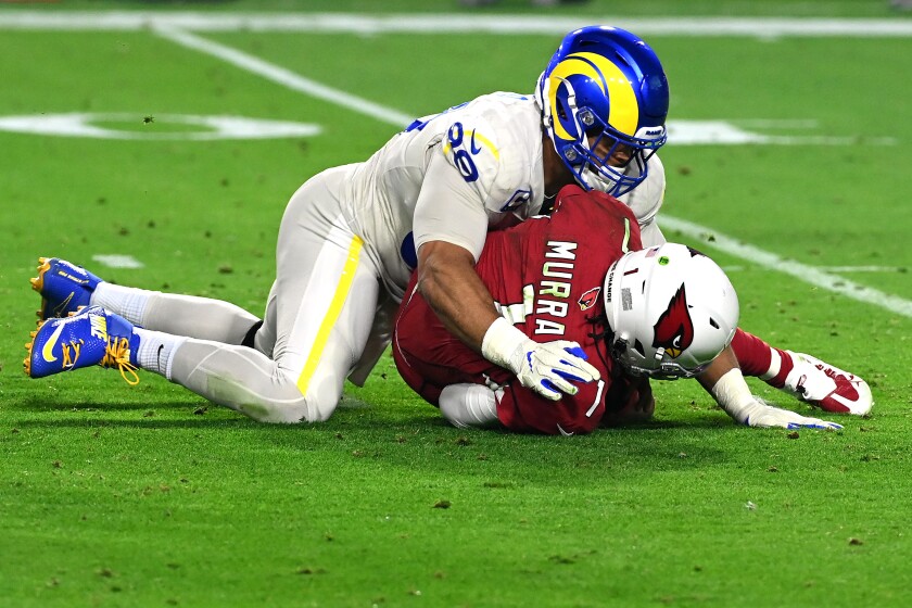 The Cardinals' Kyler Murray is sacked by the Rams' Aaron Donald.