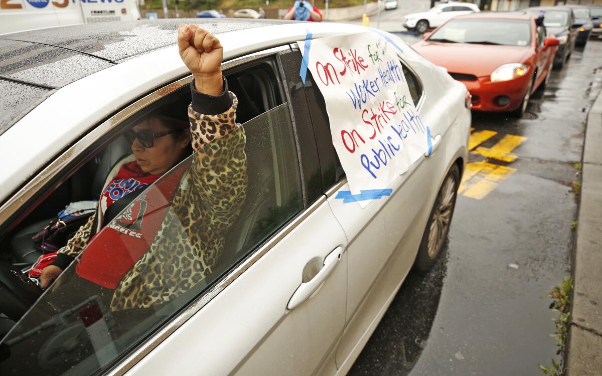 Fanny Ortiz, a union organizer, at a "drive-through strike line" to demand that management do more to keep workers safe.