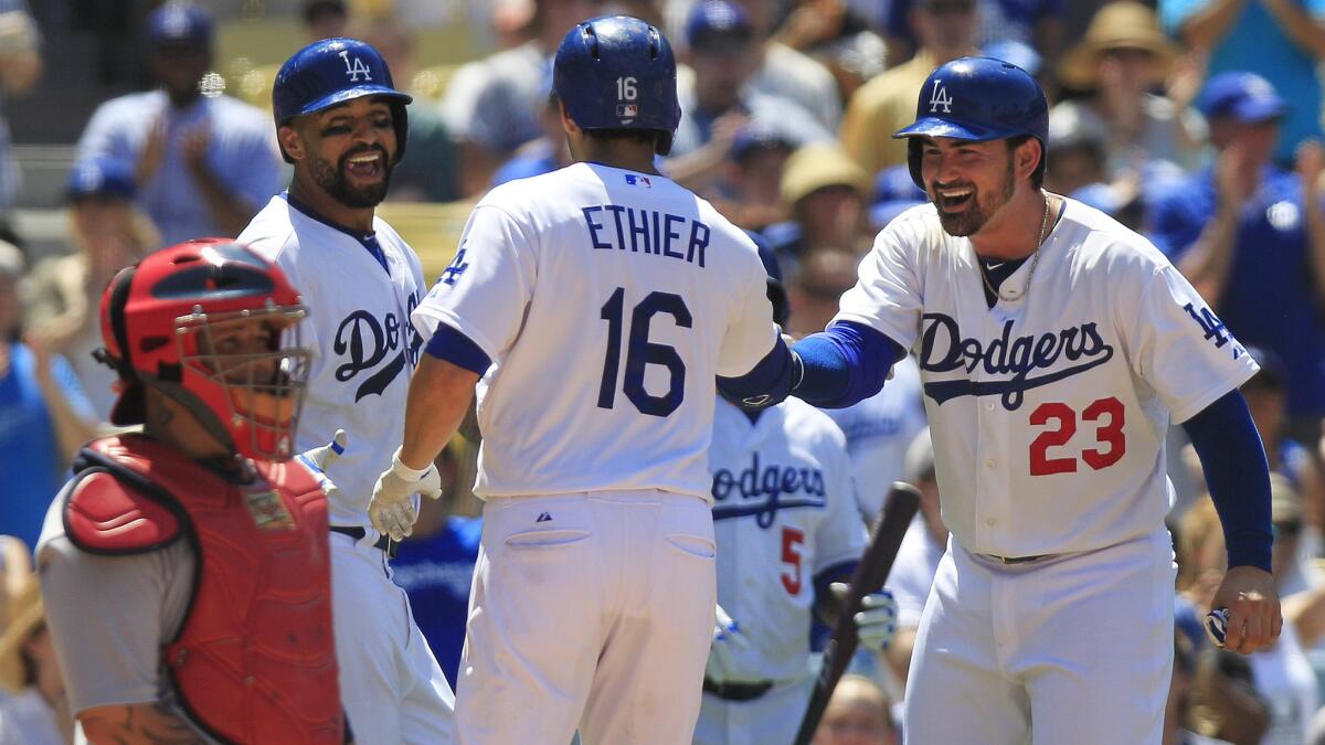 Dodgers center fielder Andre Ethier, center, is congratulated by teammates Matt Kemp, second left, and Adrian Gonzalez after hitting a three-run home run as St. Louis catcher Yadier Molina looks on during the fifth inning of Sunday's game.