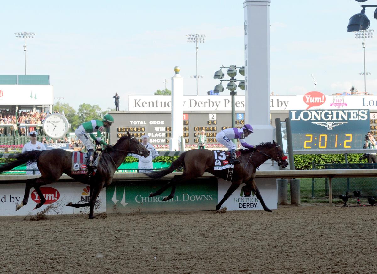 Nyquist, ridden by jockey Mario Gutierrez, holds off Exaggerator down the stretch to win the Kentucky Derby.