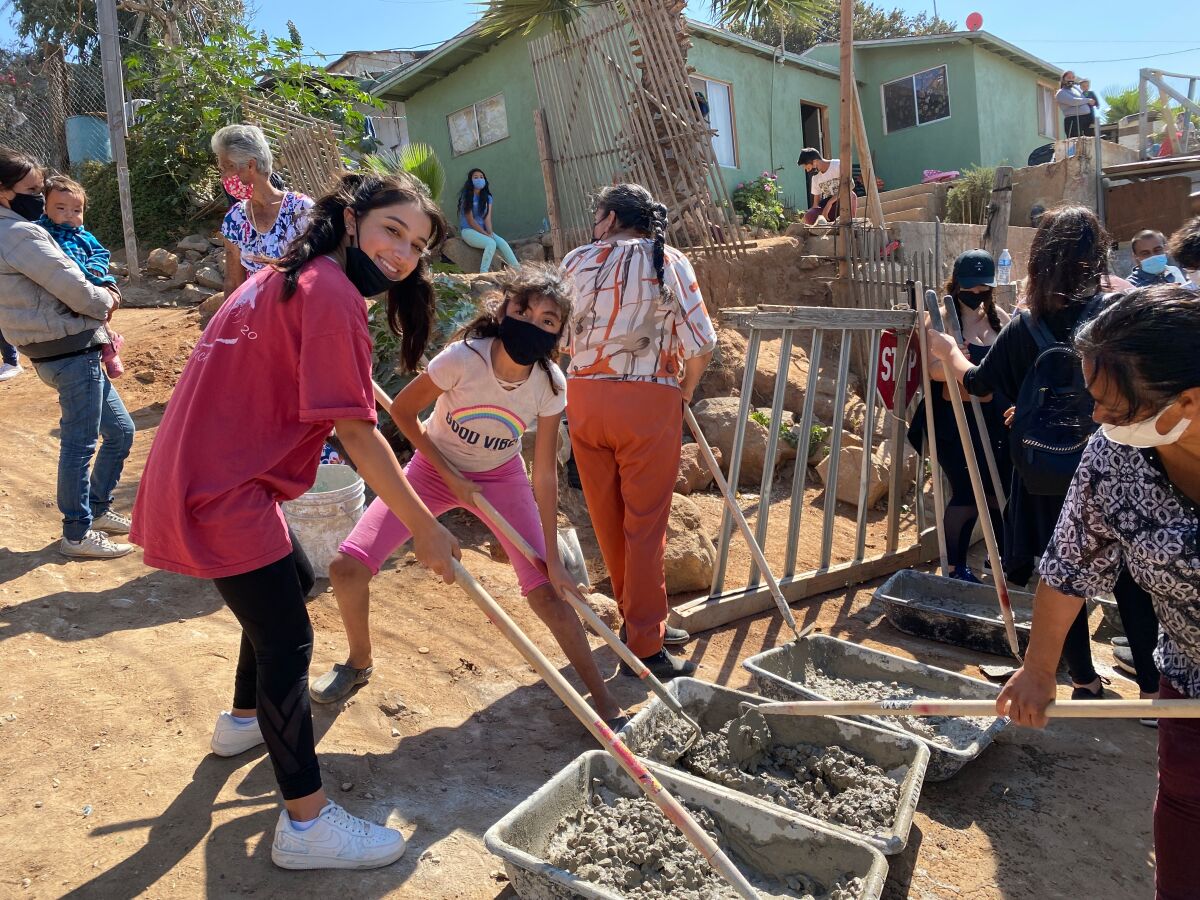 After the pandemic, Daniella Benitez, in pink shirt, returned to Tijuana Sept. 18 with Build A Miracle to prepare concrete.