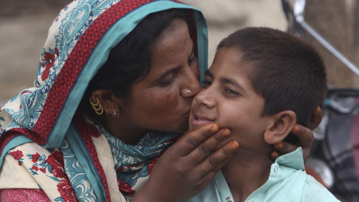 A Pakistani mother kisses her son Ali Raza, 10, infected with HIV in a village near Ratodero, a small town in southern province of Sindh in Pakistan, Thursday, May 16, 2019.