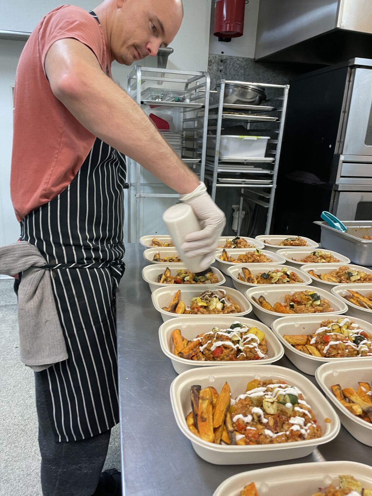 Chef and La Jolla resident Alec Hurley prepares food at Deeply Nutrient's catering service.