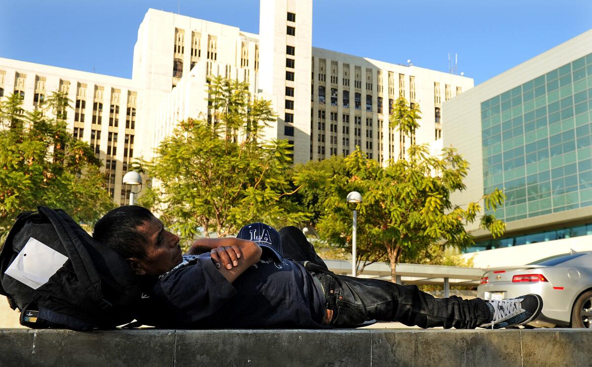 A homeless man sleeps outside Los Angeles County-USC Medical Center, one of 14 trauma centers in Los Angeles County.