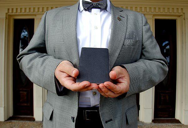 Embalmer Glenn Bergeron holds a booklet of the names of those he has worked on at the Thibodaux Funeral Home in Thibodaux, La.