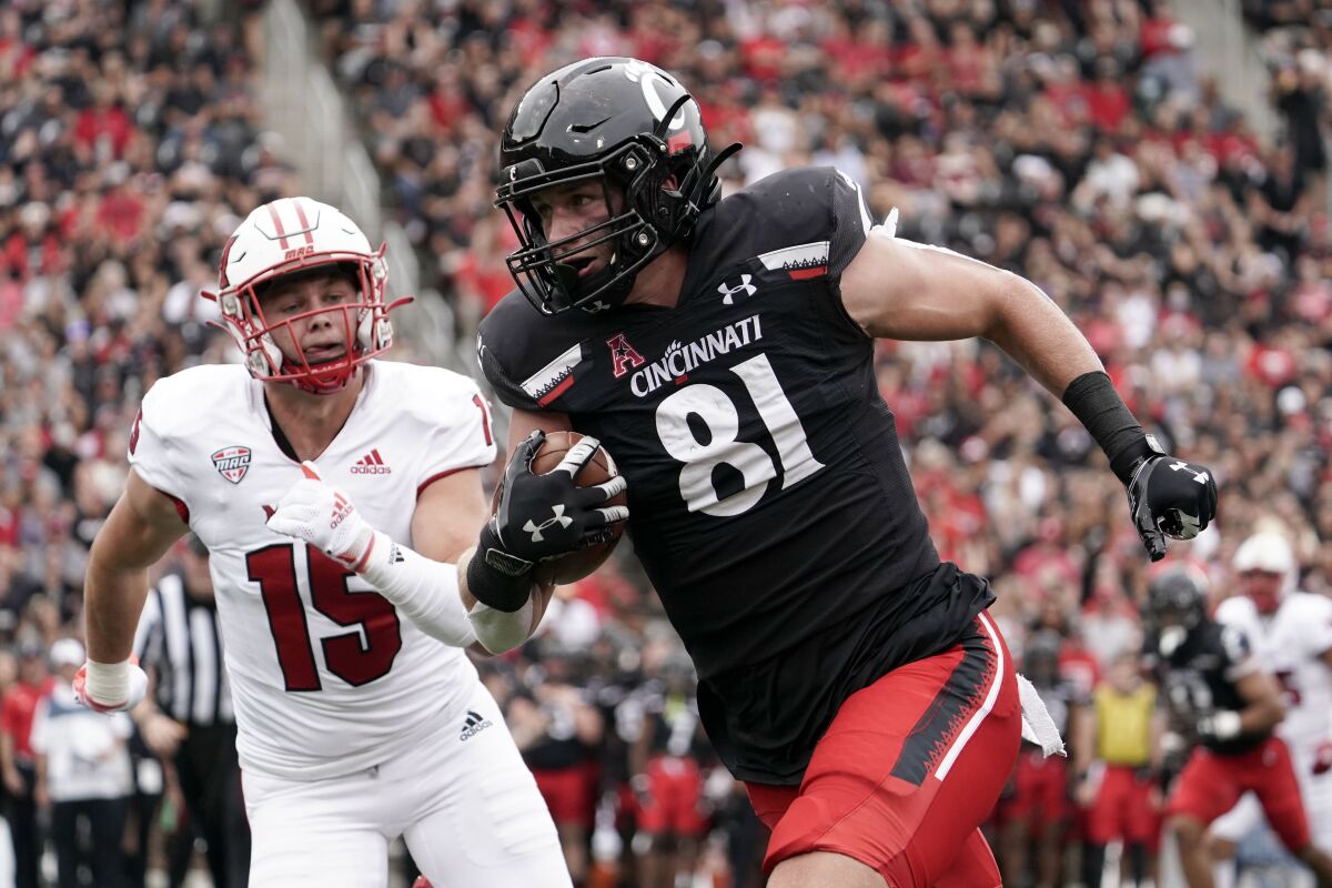 Cincinnati tight end Josh Whyle (81) runs after catching a pass for a touchdown during the first half of an NCAA college football game against Miami (Ohio), Saturday, Sept. 4, 2021, in Cincinnati. (AP Photo/Jeff Dean)