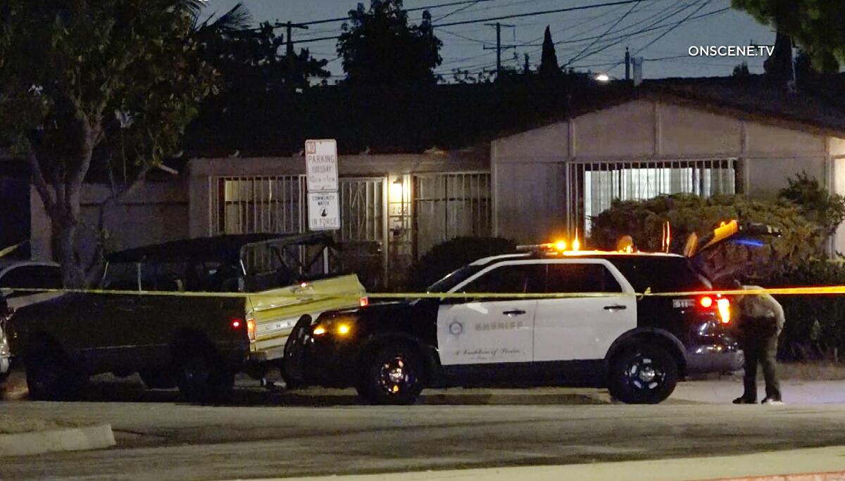 A police vehicle behind yellow crime-scene tape.